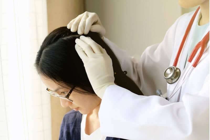 doctor treating woman for demodex hair mites