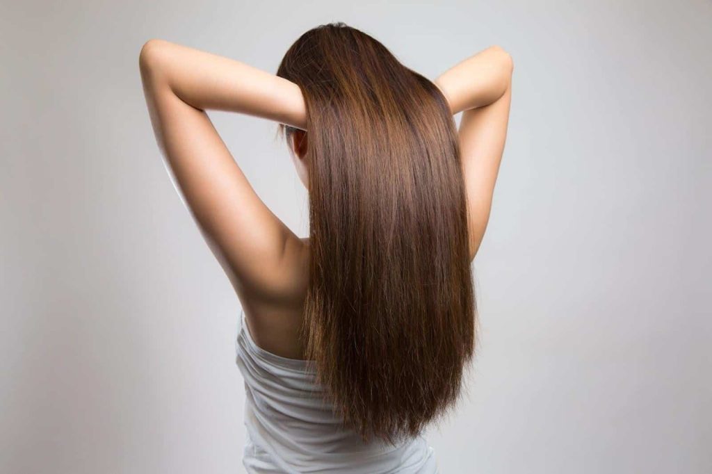 Woman exploring non-invasive hair thinning solutions in Singapore - Papilla by Kim Lim