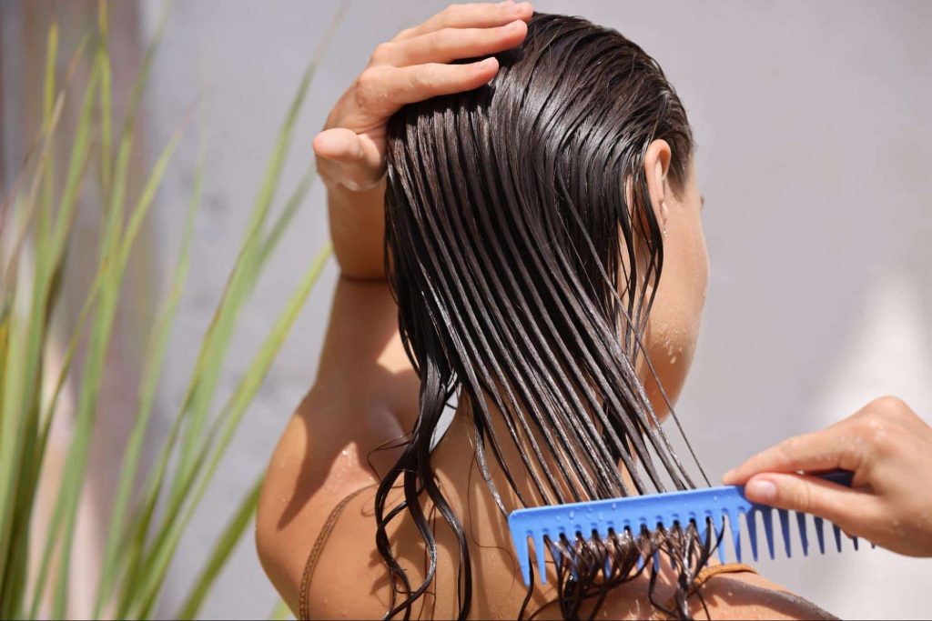 Woman with a comb promoting healthy hair growth and reducing hair fall in Singapore - Papilla by Kim Lim
